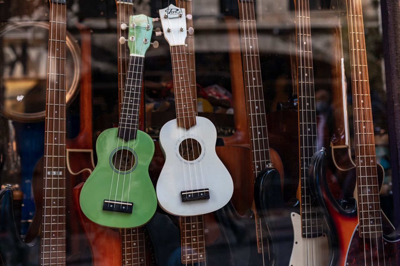 Crafting Captivating Headlines: Your awesome post title goes here Shop window showcasing a collection of colorful ukuleles and guitars.